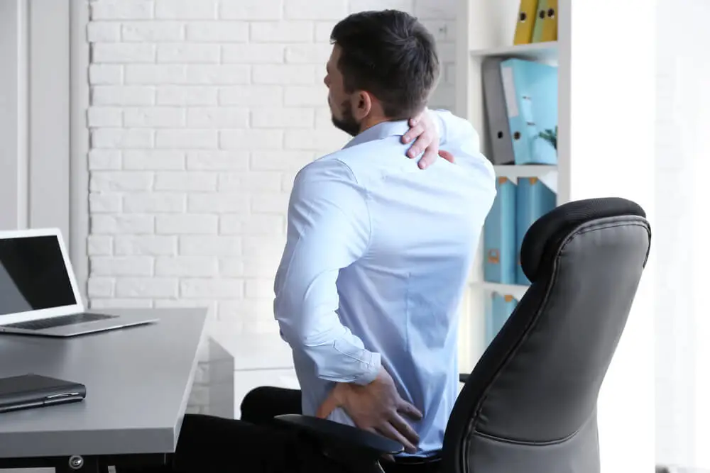 The stiff neck and lower back pain connection shutterstock 617543948 the stiff neck and lower back pain connection