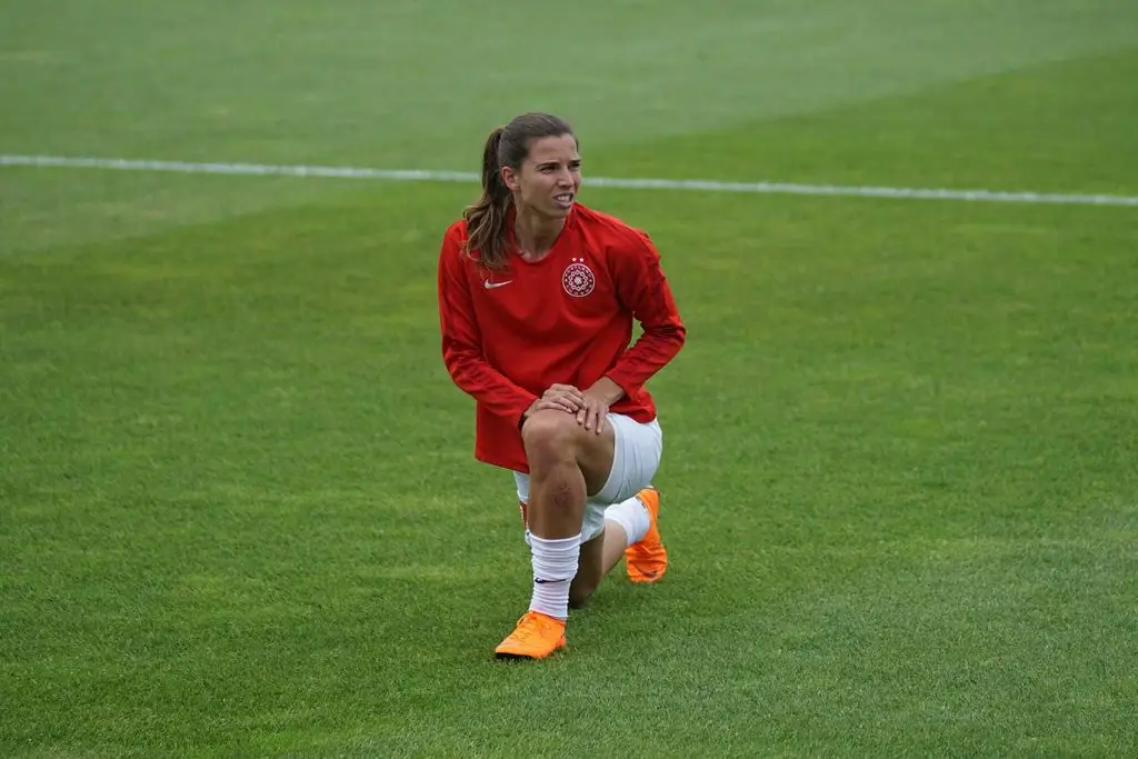 ACL injury lessened stretching acl injury prevention female athlete stretching leg on field