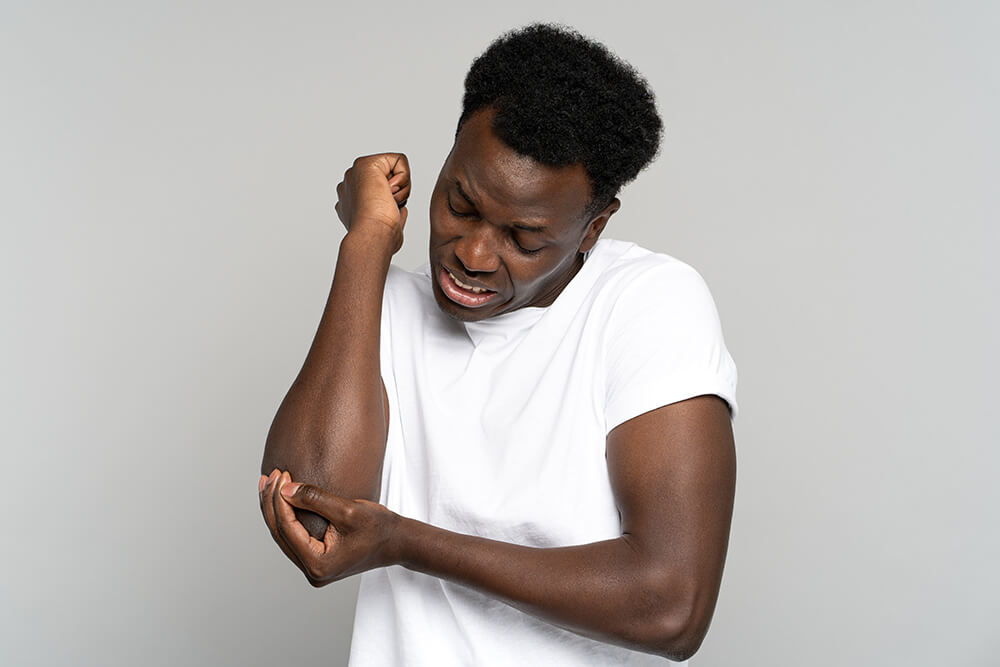 Elbow bone spurs: Causes, symptoms and treatment options unhappy black man in t shirt suffers her elbow joi 2022 11 15 04 06 10 utc elbow bone spurs: causes, symptoms and treatment options elbow pain