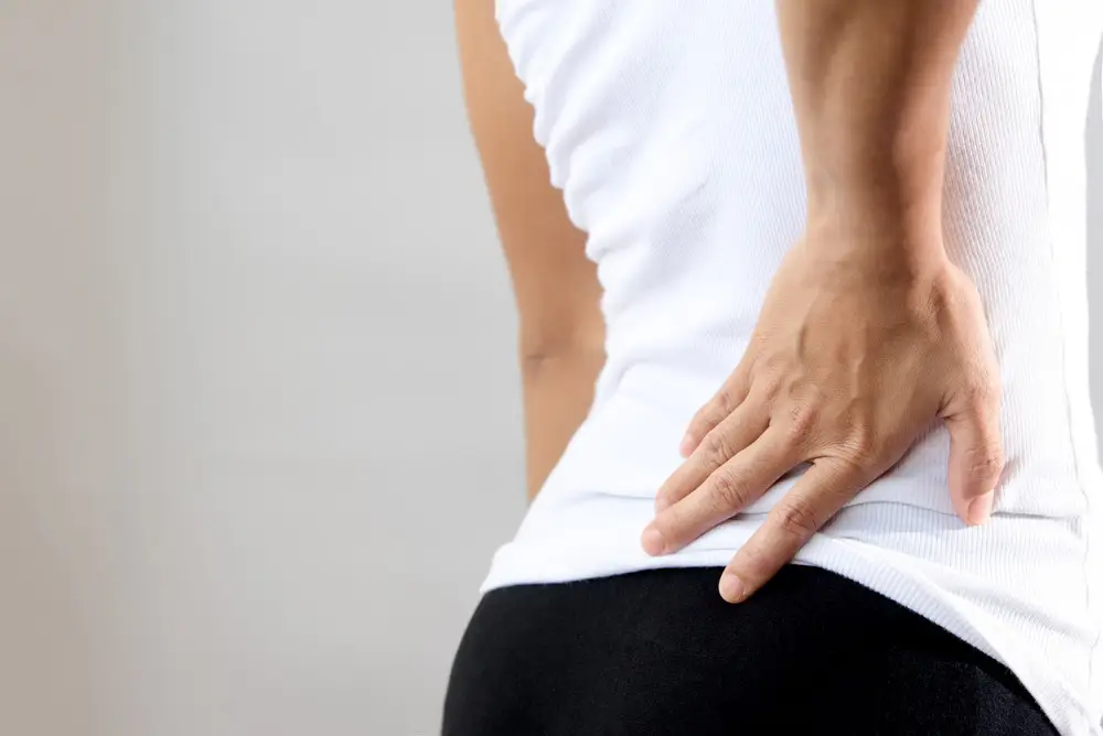 5 physical therapy exercises for lower back pain low back pain in woman worker 2023 01 06 23 48 23 utc 1 woman with low back pain.