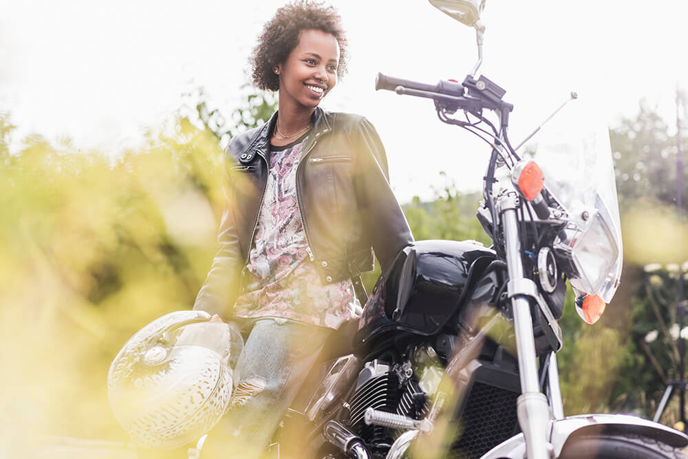 4 PT treatment methods for those with a motorcycle injury smiling young woman with her motorcycle 2023 11 27 05 17 17 utc 4 pt treatment methods for those with a motorcycle injury auto accident